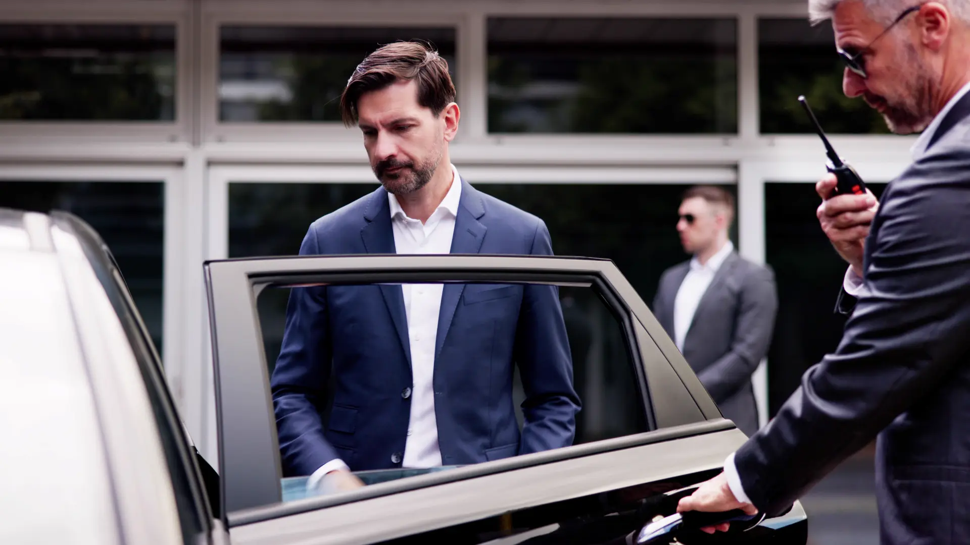 Professional chauffeur with luxury limousine for VIP transport in Geneva